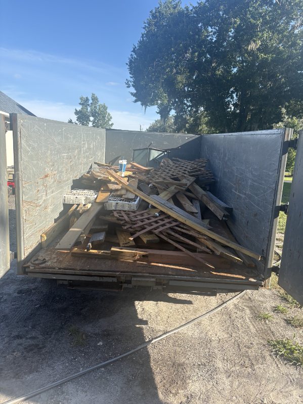 Lynch Haul dump trailer loaded with wood and debris from a cleanout